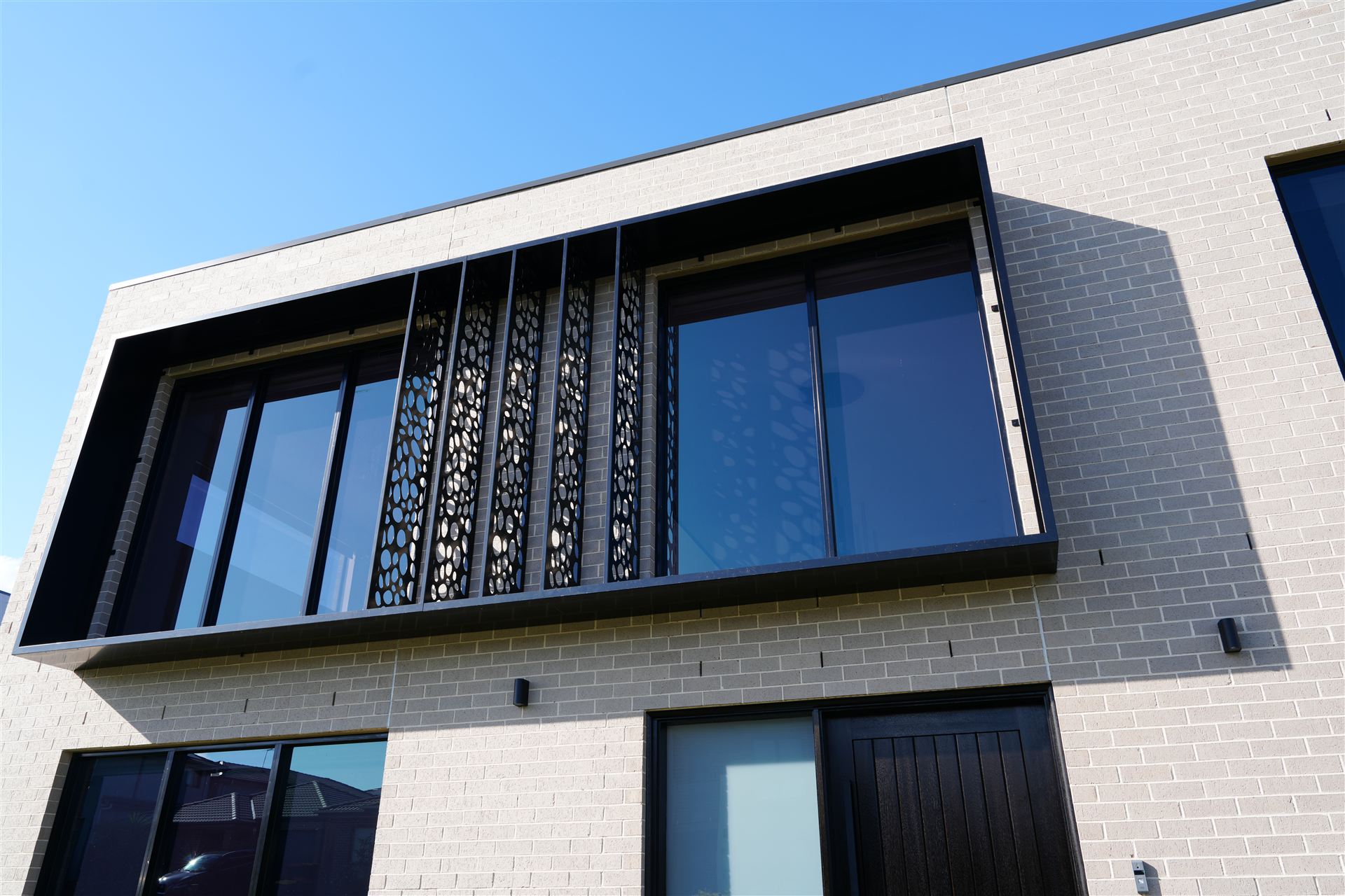 Brickwork, window detailing and a decorative screen on a completed Auzzy Projects home in Sydney's North West